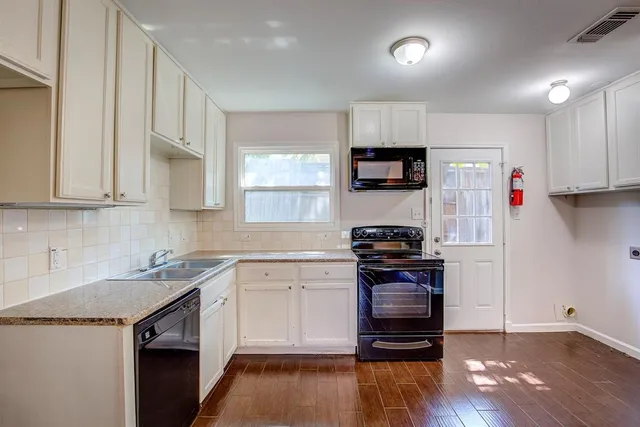 a kitchen with stainless steel appliances granite countertop a stove and a refrigerator