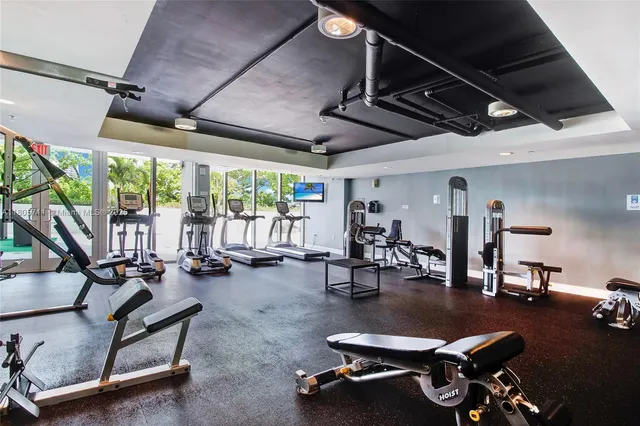 a room with gym equipment and a large window