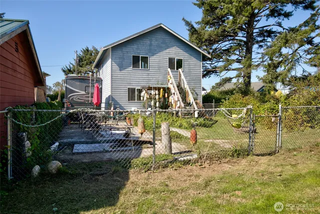 a house view with a garden and trees