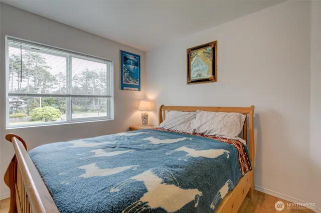 a bed sitting in a bedroom next to a window