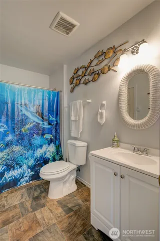 a bathroom with a sink toilet and a mirror