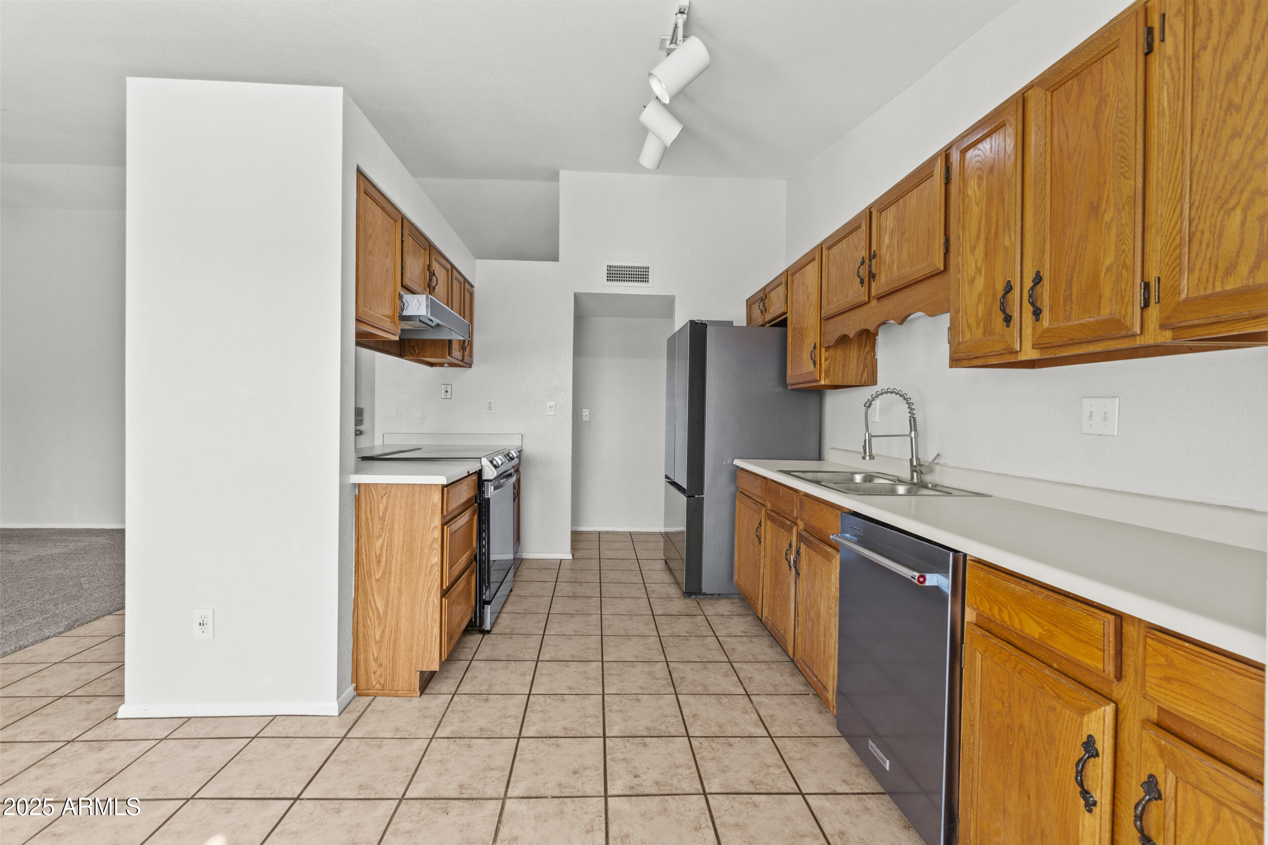 4119 West St John Road Glendale, AZ 85308 - Photo 12 of 29 a kitchen with stainless steel appliances granite countertop a sink and cabinets