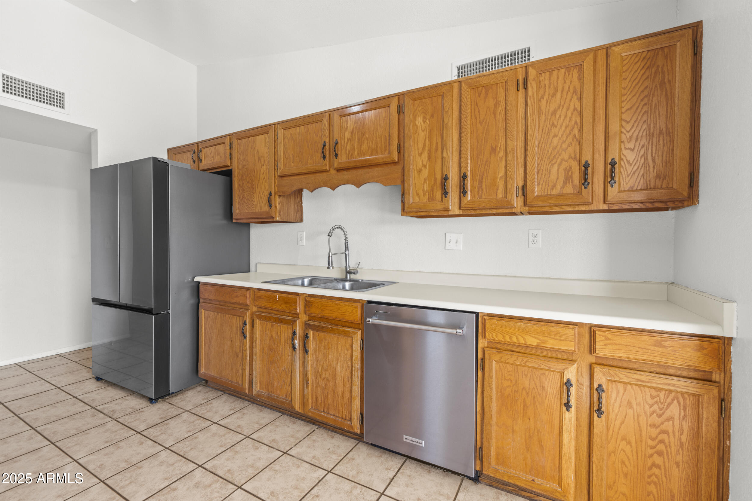 4119 West St John Road Glendale, AZ 85308 - Photo 13 of 29 a kitchen with stainless steel appliances granite countertop a refrigerator and a sink