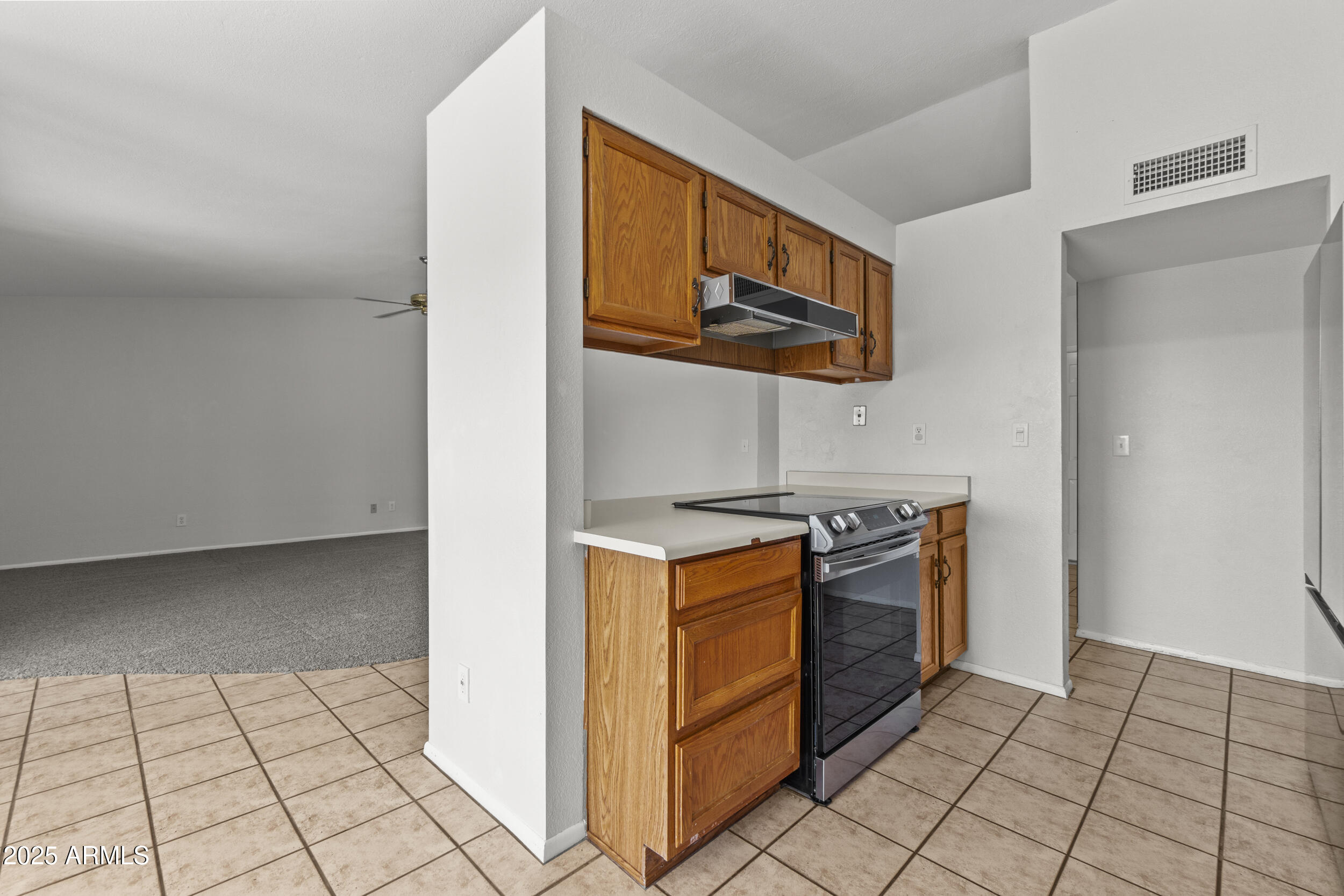 4119 West St John Road Glendale, AZ 85308 - Photo 14 of 29 a kitchen with a stove top oven and cabinets