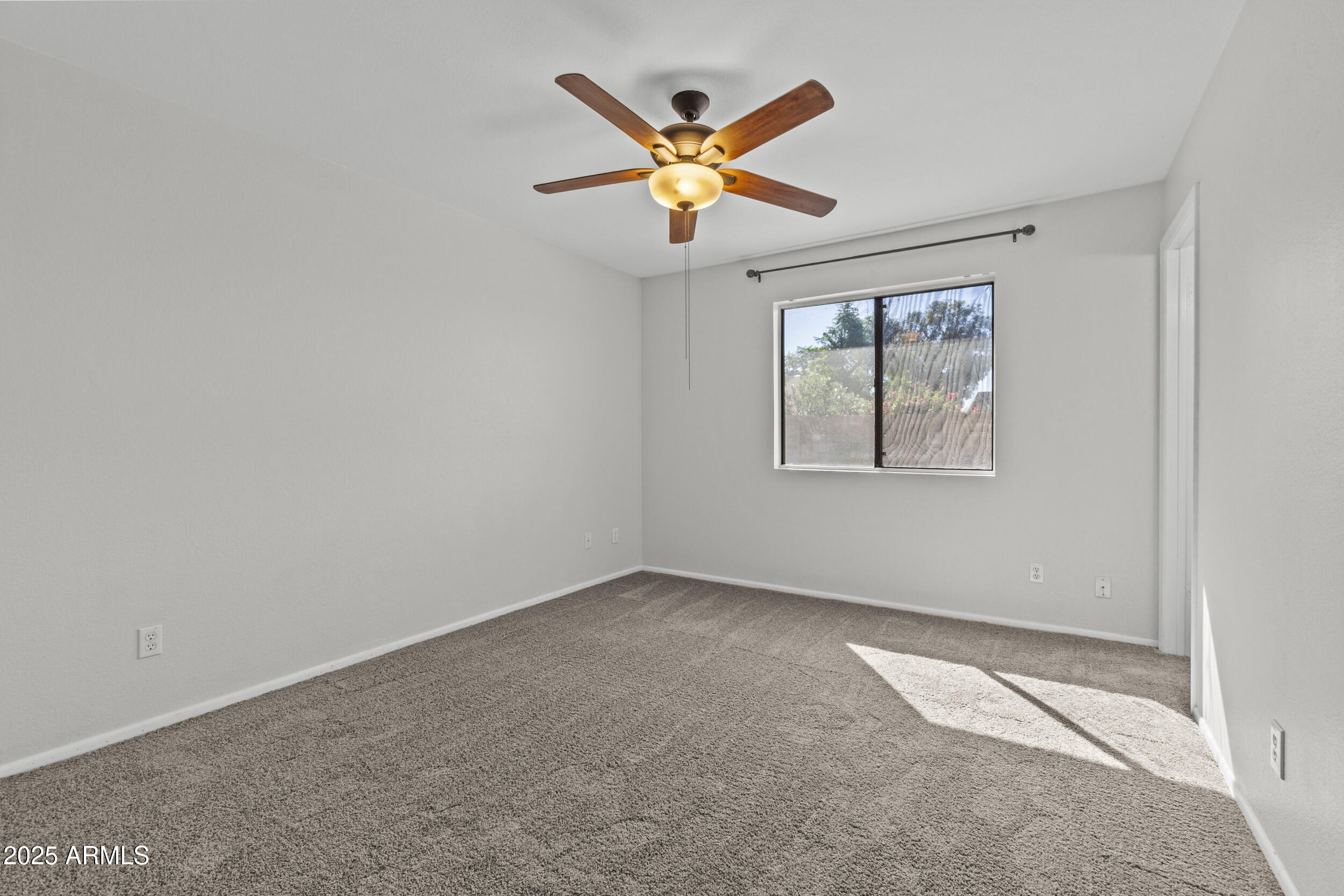 4119 West St John Road Glendale, AZ 85308 - Photo 15 of 29 an empty room with ceiling fan and windows