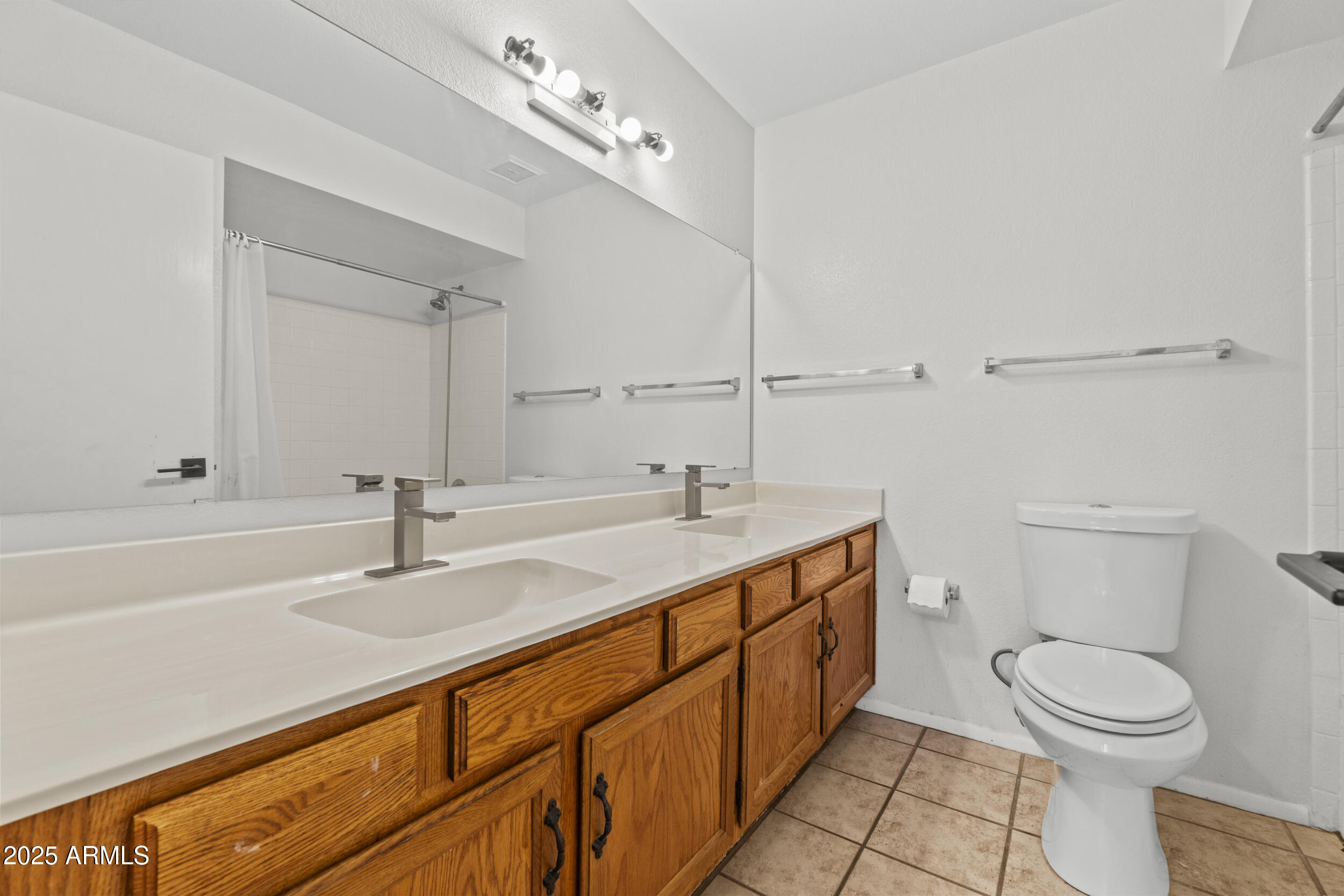 4119 West St John Road Glendale, AZ 85308 - Photo 21 of 29 a bathroom with a toilet a sink and mirror
