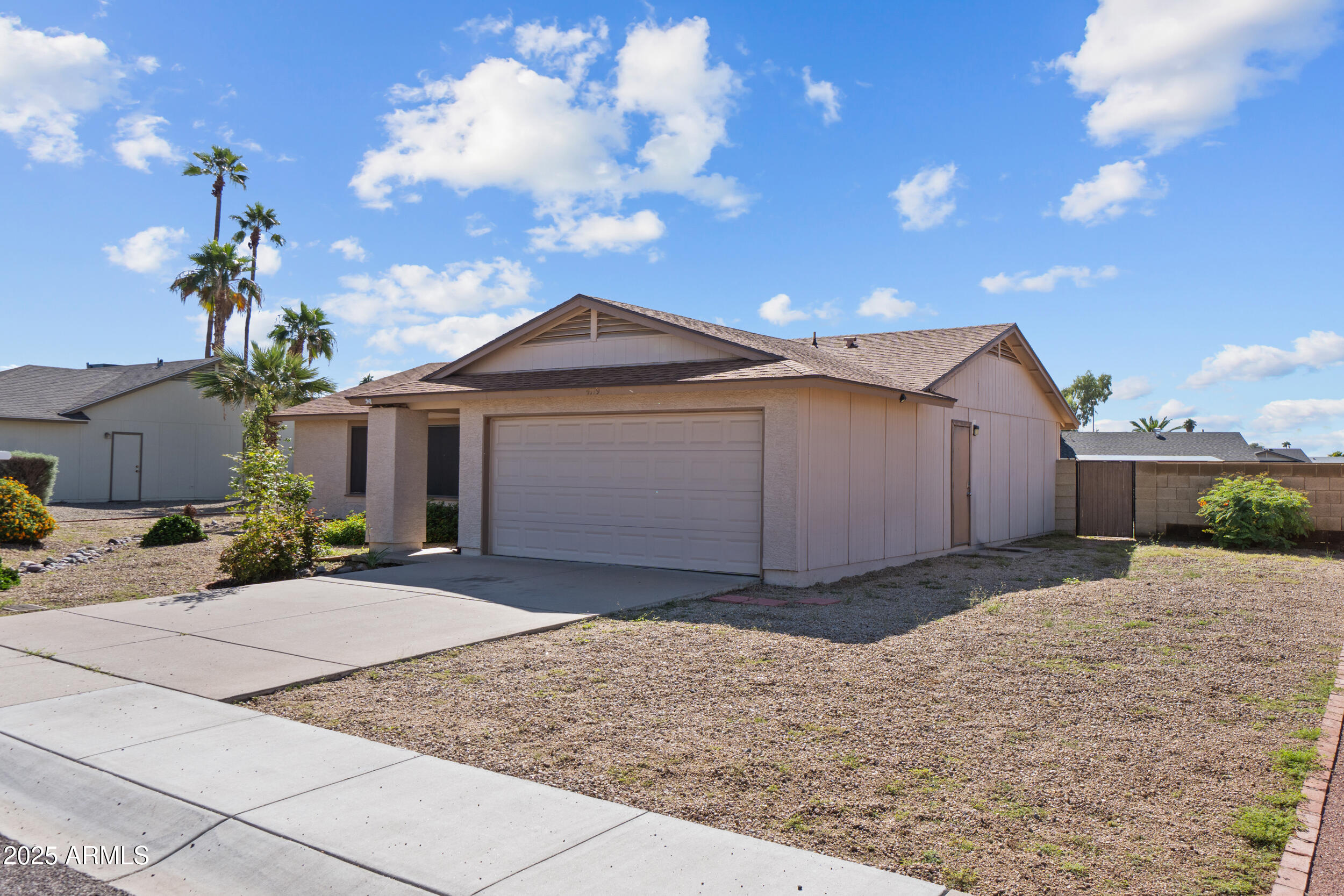 4119 West St John Road Glendale, AZ 85308 - Photo 3 of 29 a front view of a house with a yard and garage