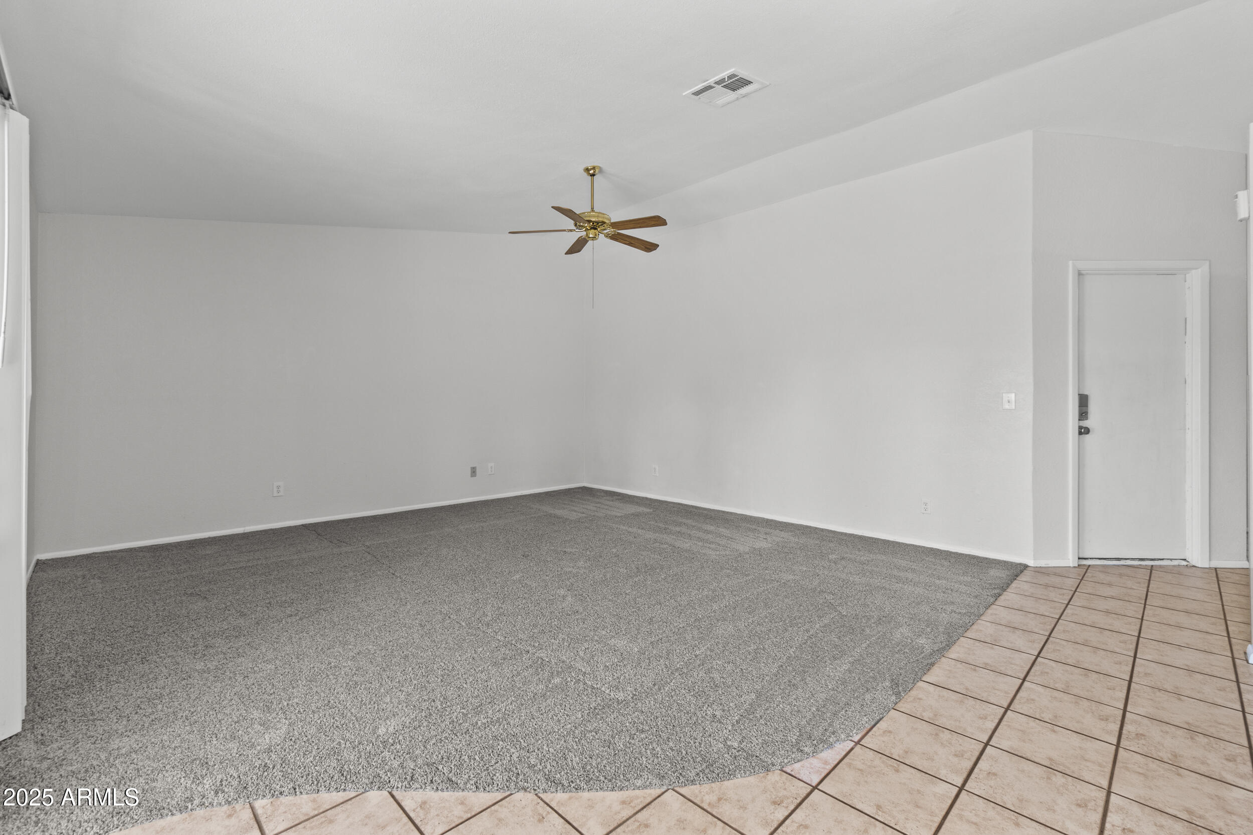 4119 West St John Road Glendale, AZ 85308 - Photo 10 of 29 an empty room with a ceiling fan and carpet