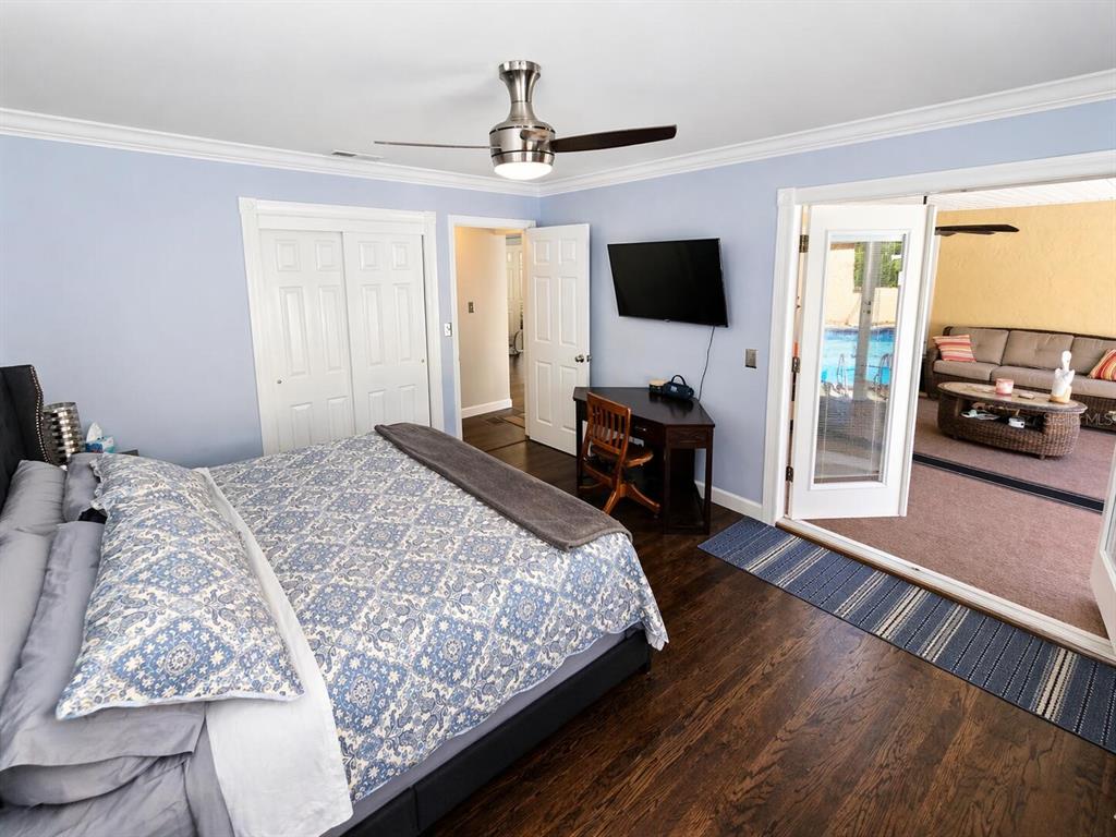 2313 Southeast 7th Street Ocala, FL 34471 - Photo 7 of 54 a bedroom with a bed window and a flat screen tv
