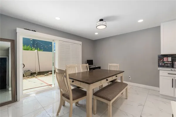 a dining room with furniture and wooden floor