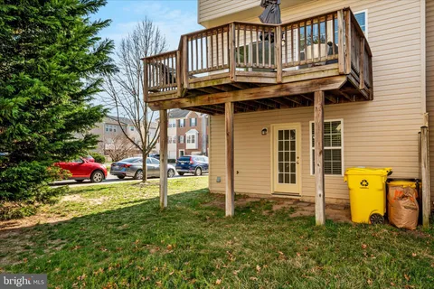 a view of a house with a yard and a wooden deck