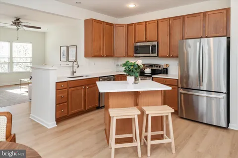 a kitchen with wooden cabinets and stainless steel appliances