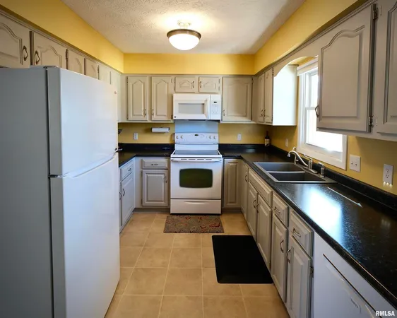 a kitchen with stainless steel appliances a refrigerator sink and stove