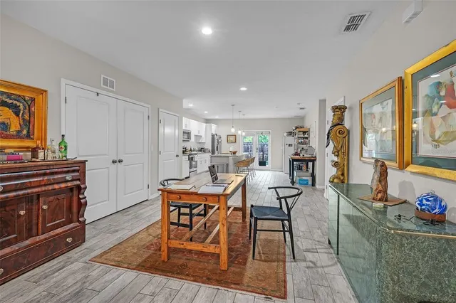 a large kitchen with lots of counter space a sink and chairs