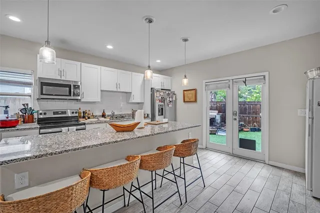 a living room with furniture a wooden floor and next to a window