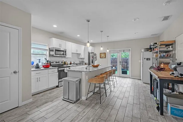 a living room with lots of furniture a rug and white walls