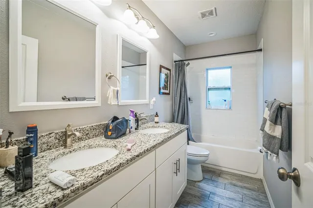 a view of a house with backyard porch and sitting area