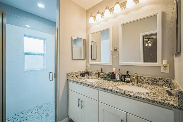 a view of a backyard with couches potted plants and wooden fence