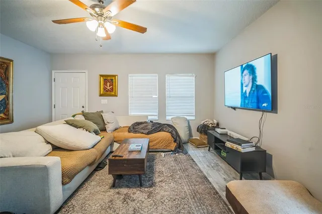a living room with furniture and a chandelier