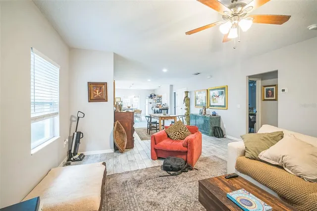 a kitchen with stainless steel appliances granite countertop a refrigerator a sink dishwasher a stove and white cabinets with wooden floor