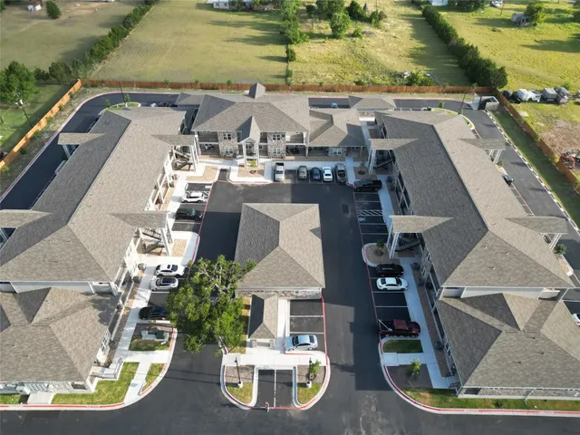 an aerial view of residential houses with outdoor space