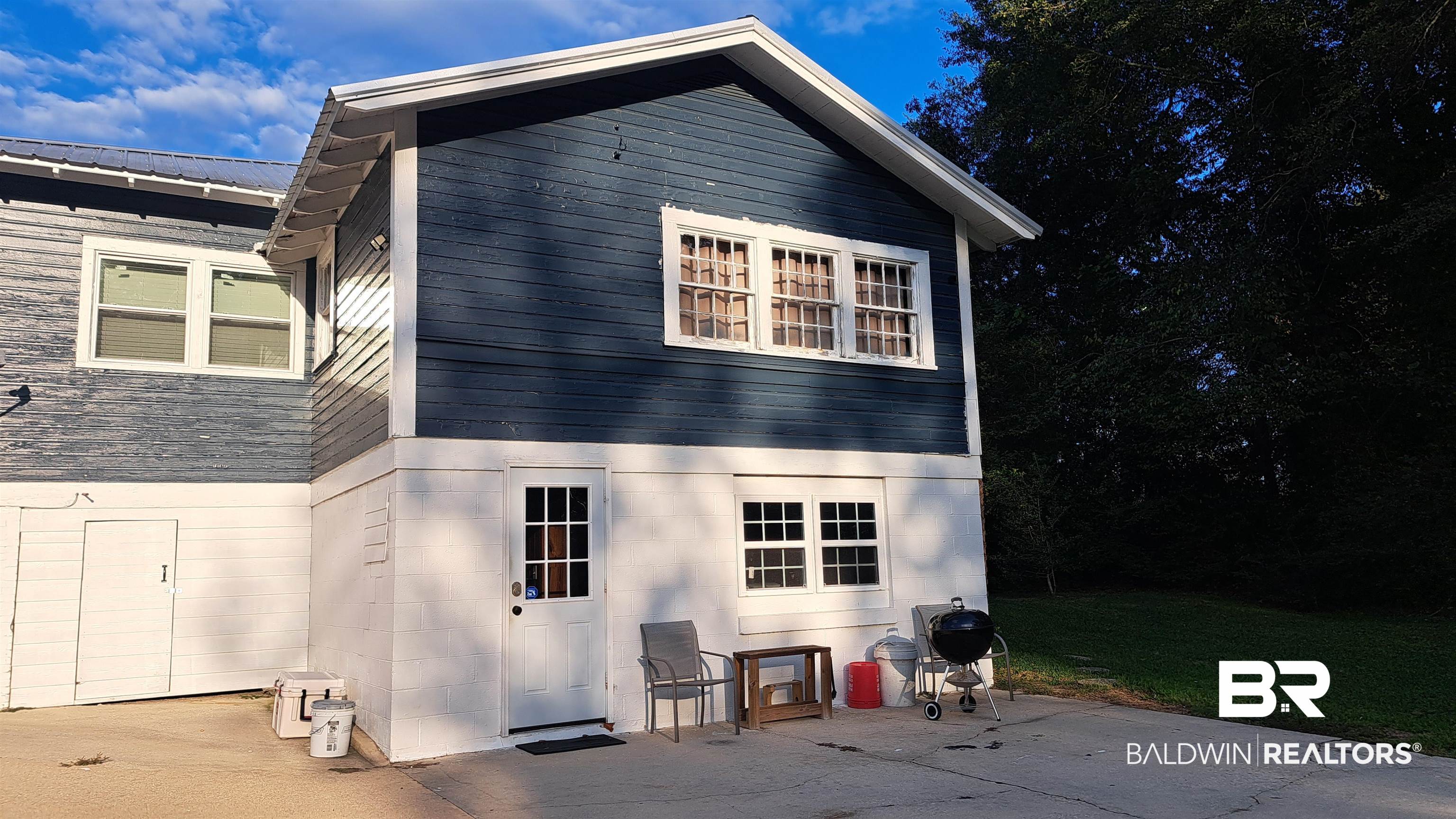 110 South Main Street Evergreen, AL 36401 - Photo 22 of 27 Two-story structure featuring a blue siding exterior and white trim