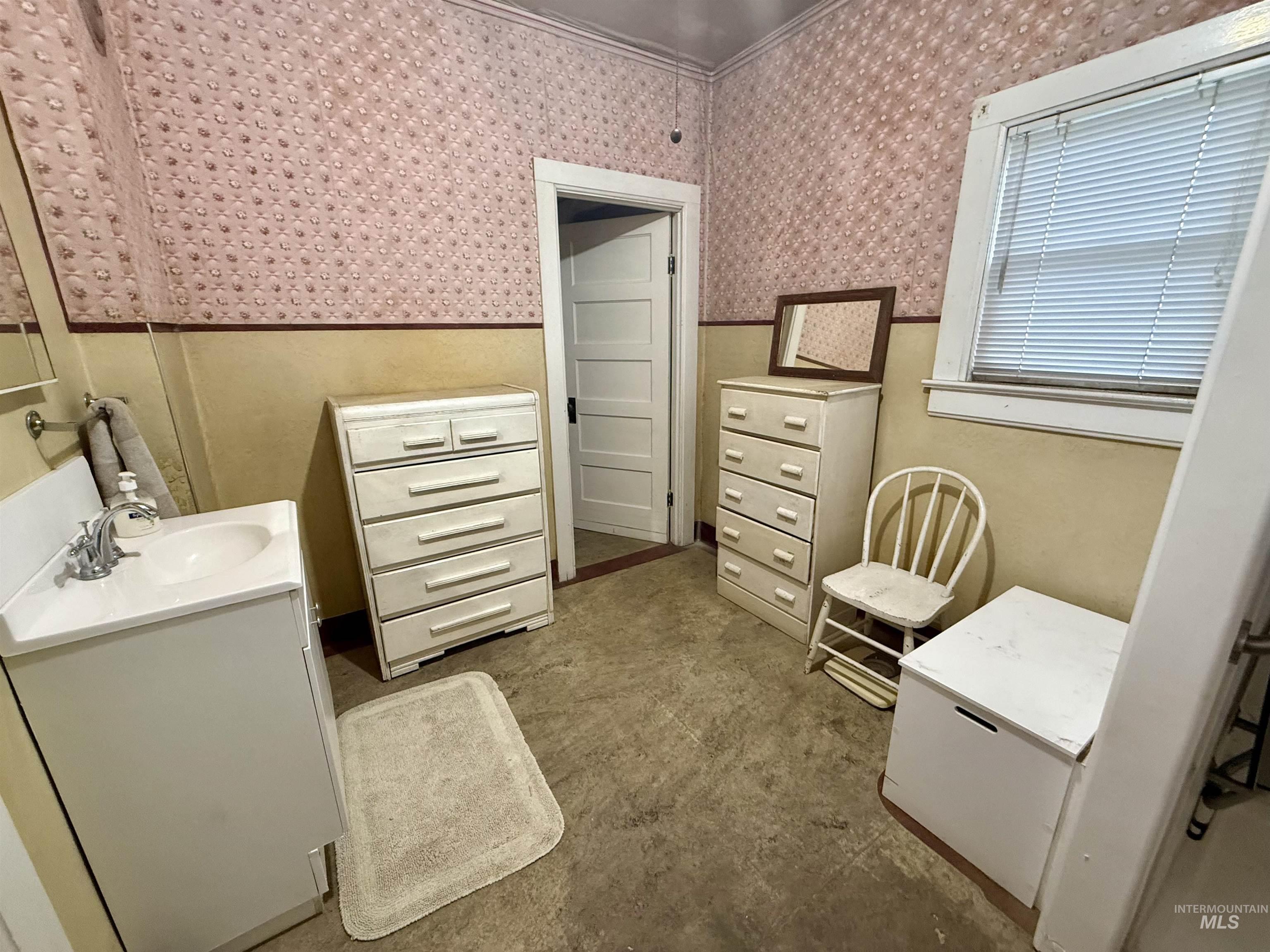 1368 Chestnut Street Clarkston, WA 99403 - Photo 16 of 25 Bathroom with vanity, wallpapered walls, and a wainscoted wall
