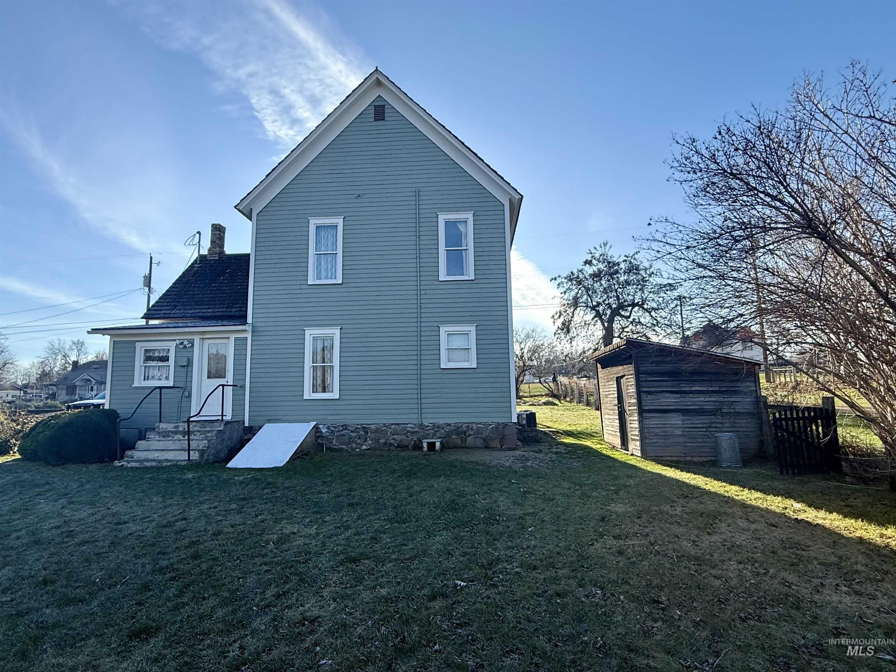 1368 Chestnut Street Clarkston, WA 99403 - Photo 3 of 25 Rear view of house with a yard and a storage shed