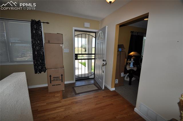 36825 East Jones Road Yoder, CO 80864 - Photo 6 of 35 Front door entrance with storm door.