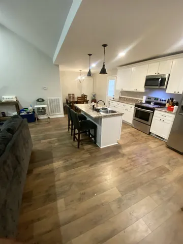 a kitchen with a sink appliances and cabinets