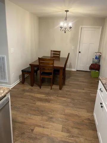 a view of a dining room with furniture and chandelier