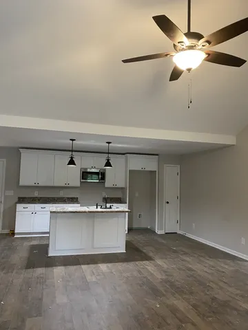 a view of kitchen with a sink cabinets and appliances