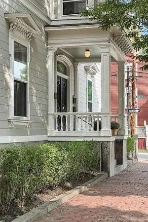 front view of a brick house with a small yard