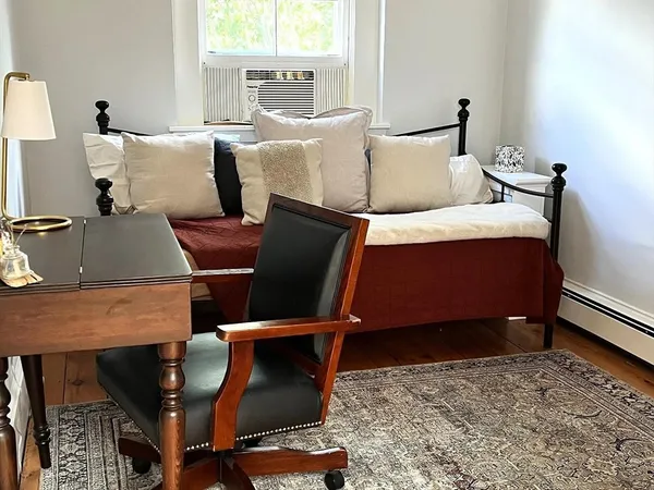 a bed room with two bed and a desk