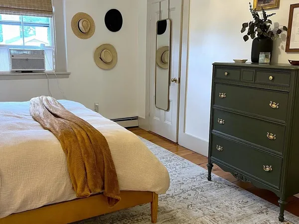 a bedroom with a bed and a potted plant