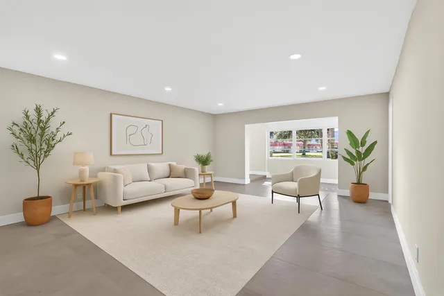 a living room with furniture and a potted plant