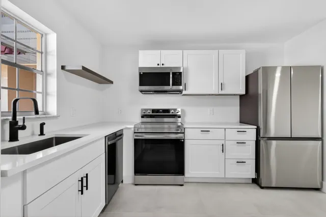 a kitchen with a refrigerator stove and sink