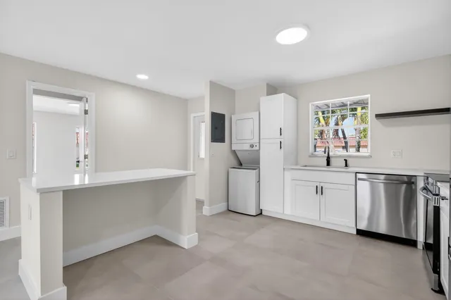 a kitchen with stainless steel appliances a stove microwave and sink