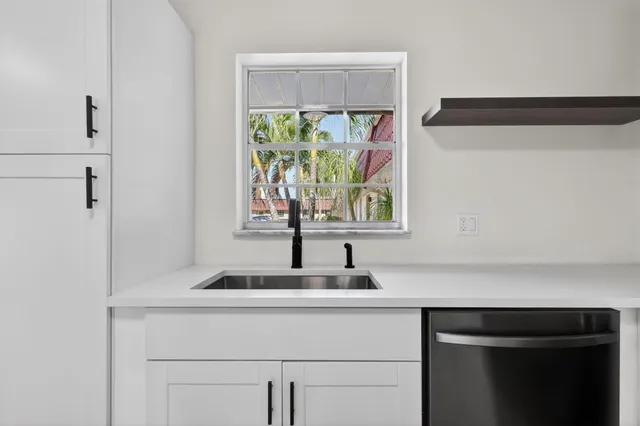 a kitchen with refrigerator a stove a sink a microwave and a refrigerator