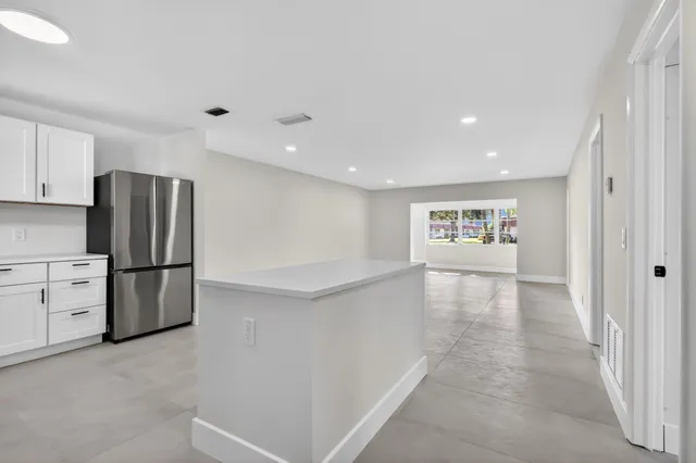 a view of a room with furniture and wooden floor
