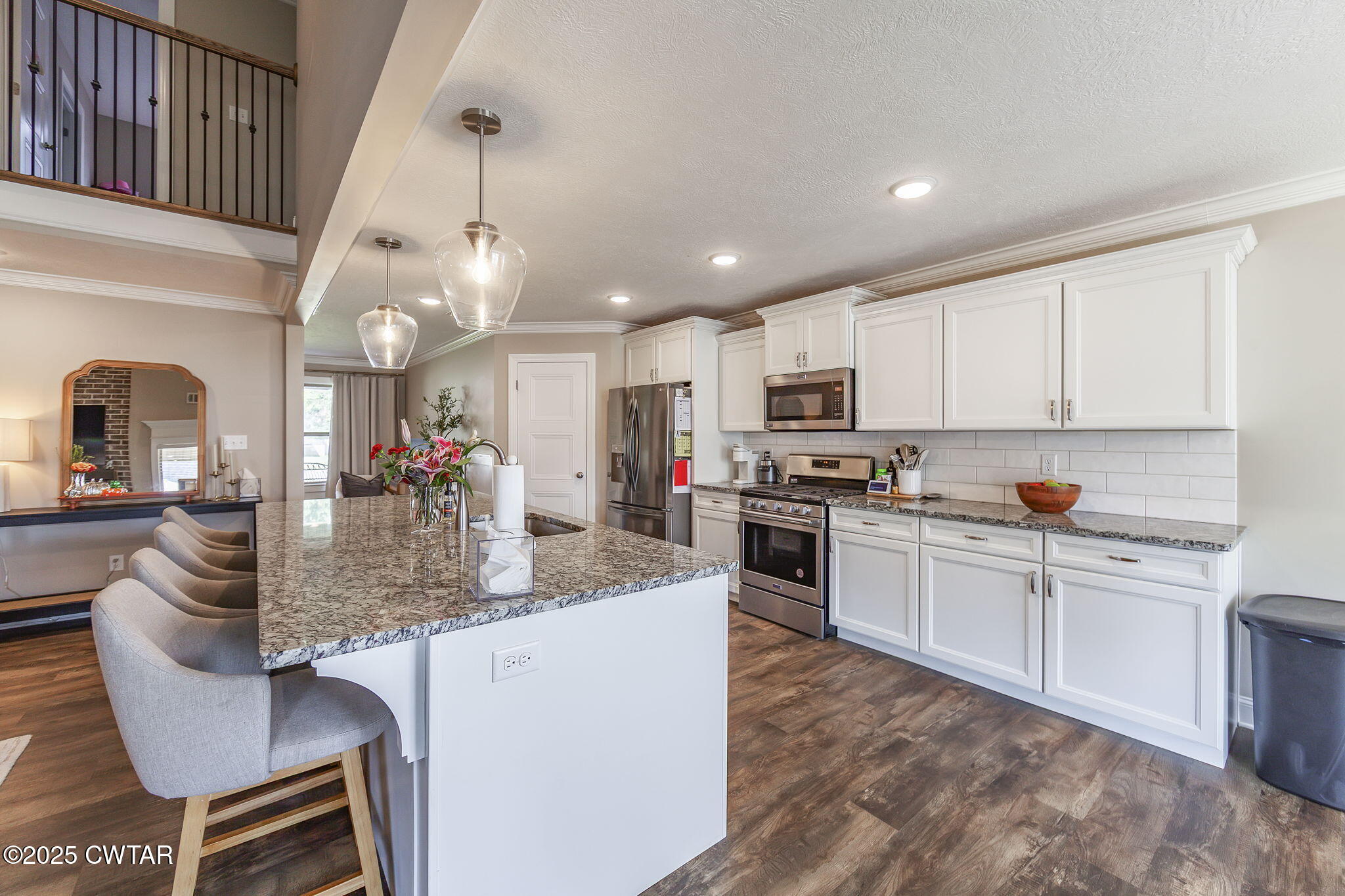 105 Fawn Ridge Lane Medina, TN 38355 - Photo 11 of 40 a kitchen with kitchen island granite countertop stainless steel appliances a sink a stove a table and chairs