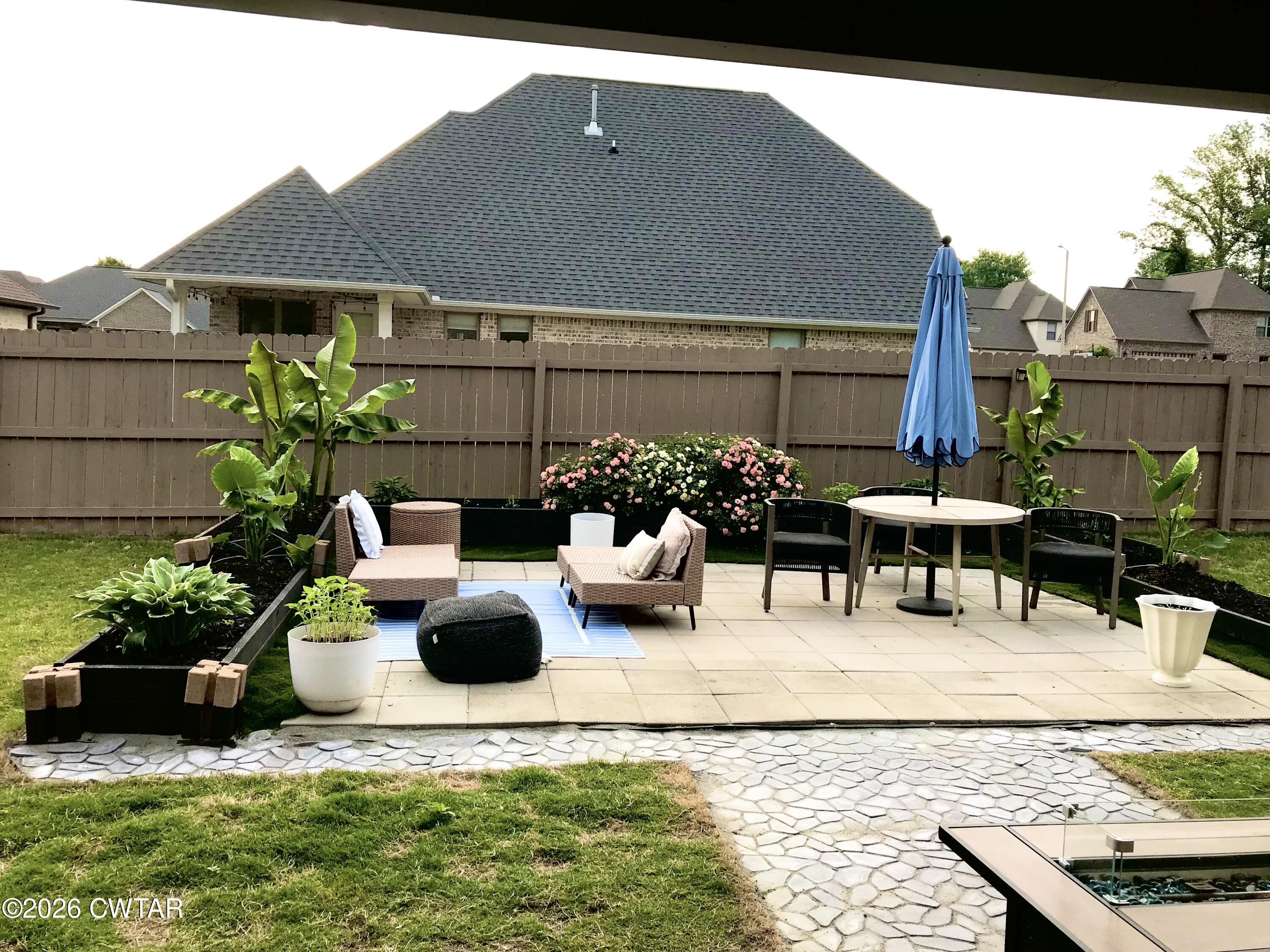 105 Fawn Ridge Lane Medina, TN 38355 - Photo 32 of 40 a view of a patio with couches table and chairs potted plants and palm tree