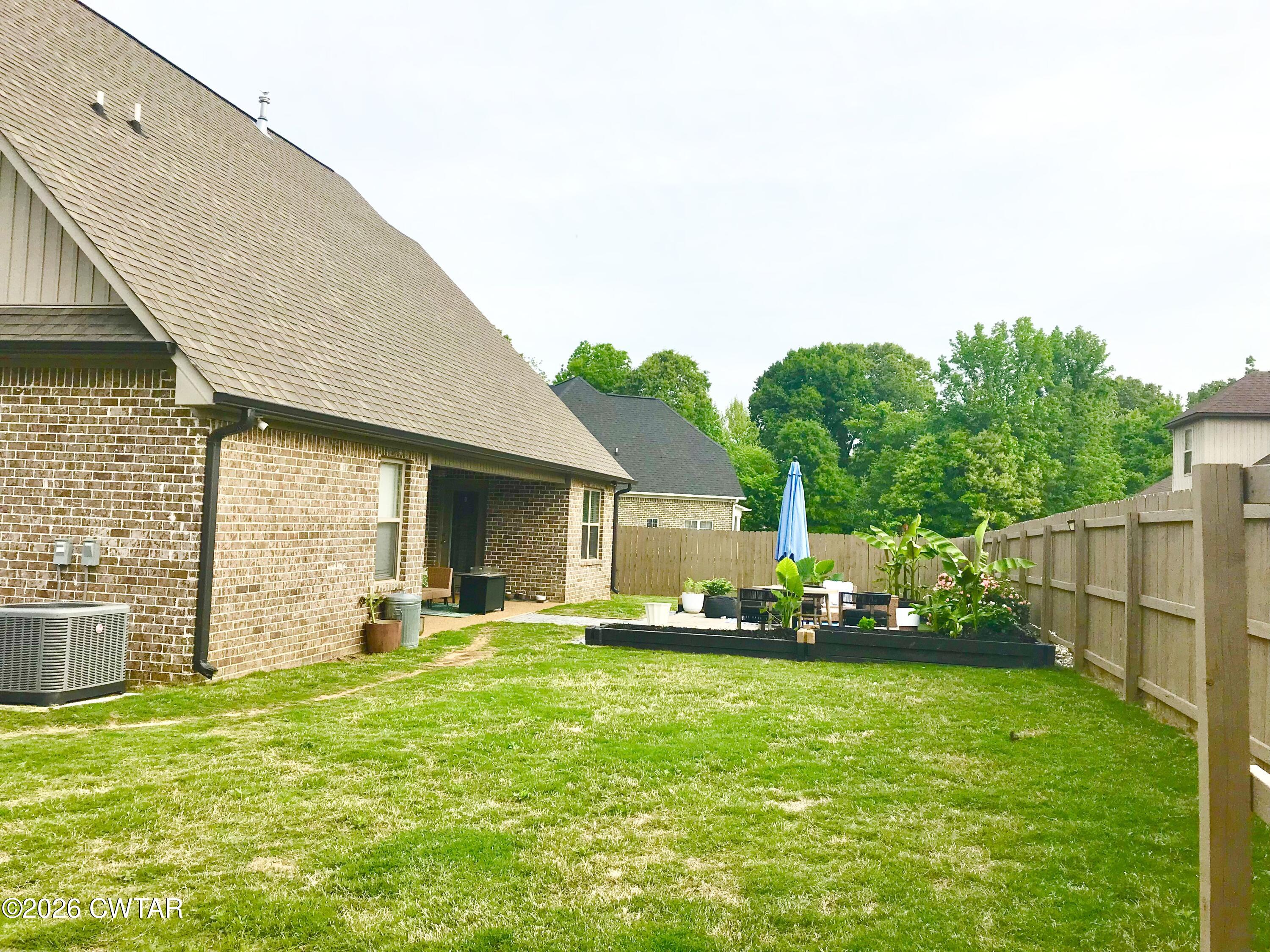 105 Fawn Ridge Lane Medina, TN 38355 - Photo 37 of 40 a front view of a house with a garden and plants