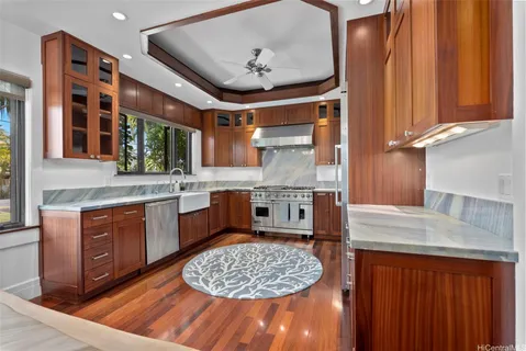 a kitchen with stainless steel appliances granite countertop a sink stove and refrigerator