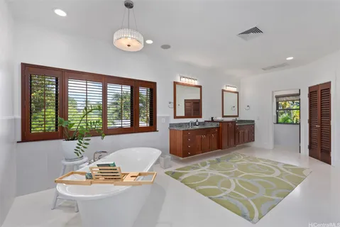 a living room with furniture a wooden floor and a flat screen tv