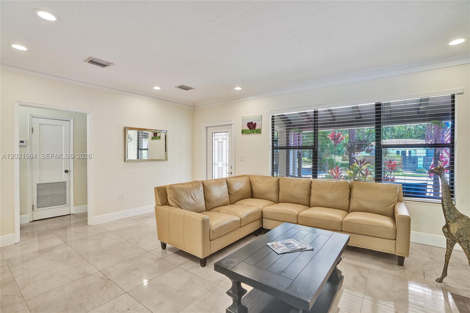 811 Northeast 73rd Street Miami, FL 33138 - Photo 9 of 51 a living room with furniture and a large window