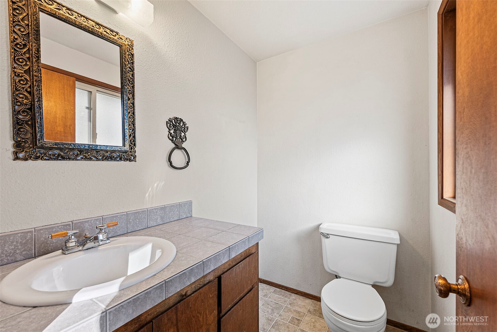8112 266th Street East Graham, WA 98338 - Photo 17 of 40 a bathroom with a granite countertop toilet sink and mirror