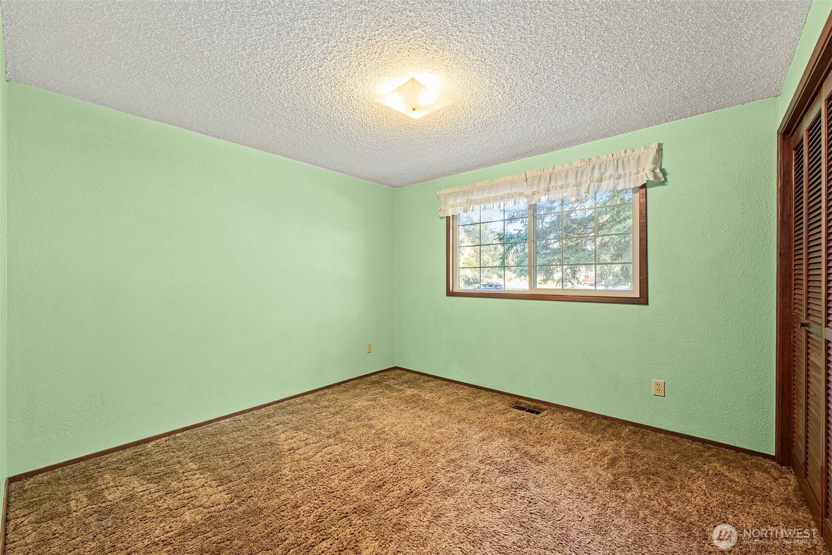 8112 266th Street East Graham, WA 98338 - Photo 18 of 40 a view of a room that has a window in it