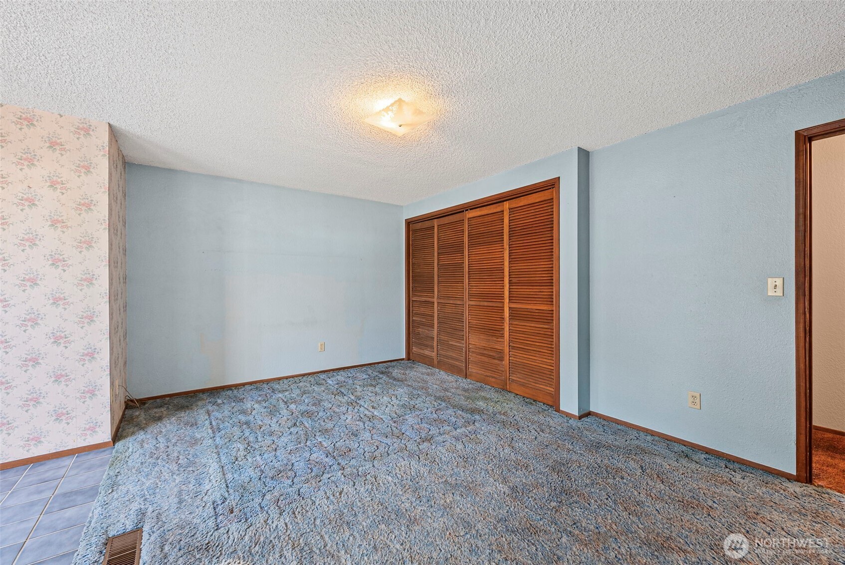 8112 266th Street East Graham, WA 98338 - Photo 21 of 40 a view of an empty room with wooden floor and a window