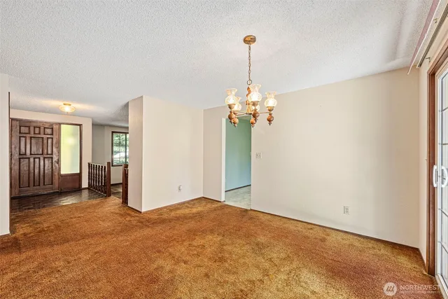 a view of an empty room and wooden floor